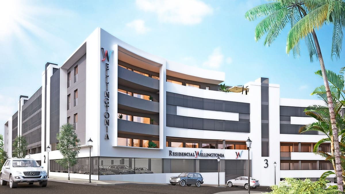Contemporary multi-story building with sleek architecture and palm trees in front, labeled Residencia Wellington.